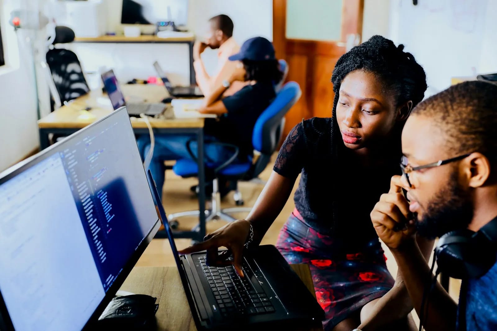 Two members of the studio reviewing work together at a monitor